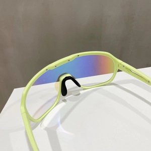 Detailed close-up of neon green sports sunglasses showing ergonomic black nose pads
