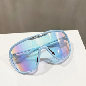 Detail of light blue oversized sunglasses with iridescent lenses and metal top bar