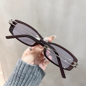 Close-up of rectangular glasses featuring silver industrial metal double-bar temples