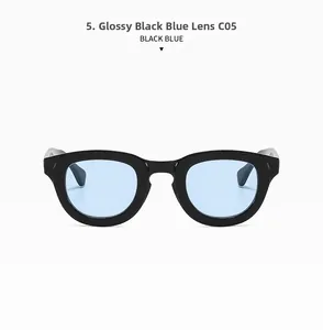 Detail view of oval retro sunglasses with bright black frames and light blue lenses