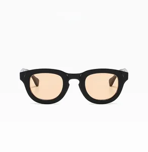 Detailed close-up of glossy black frames with light brown lenses and metal hinges