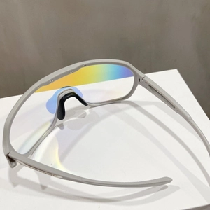 Detail view of sports sunglasses featuring rainbow reflective lenses and rubber nose pads