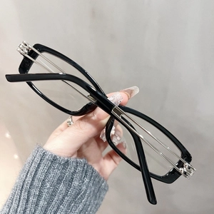 Detail of square black TR90 frames with hollow metal temples for a retro fashion look