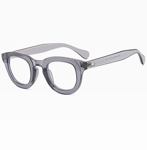 Detail of transparent grey round glasses frame with silver metal temple hinges
