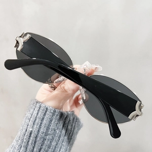 Retro cat-eye sunglasses with vintage silver cross metal accents and dark oval lenses