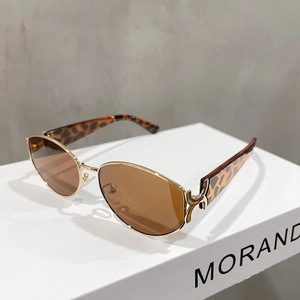 Detailed view of gold metal hinges and leopard print temples on cat-eye sunglasses