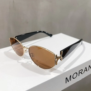 Detail of vintage cat-eye sunglasses with gold metal frame and unique chain link hinges
