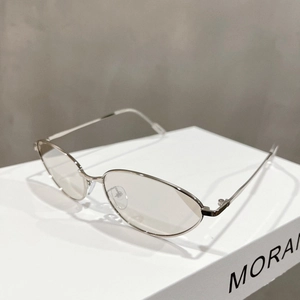 Detail view of oval silver metal frame glasses with adjustable nose pads and thin temples