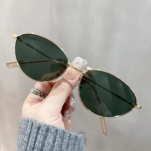 Vintage gold metal cat eye sunglasses with dark green lenses for a classic retro style