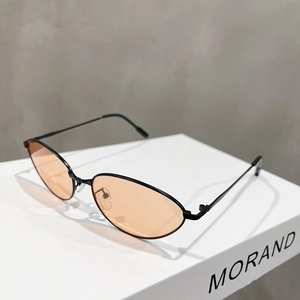 Detail view of vintage cat-eye glasses with thin black metal frames and amber lenses
