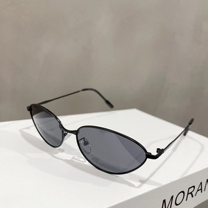 Macro shot of minimalist black metal cat-eye frame sunglasses with dark gray lenses