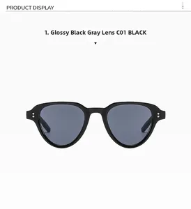Close-up of black retro sunglasses with metal rivet details and grey tinted lenses