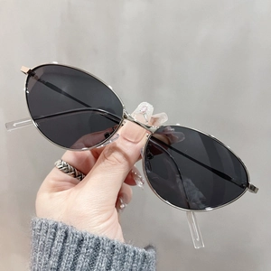 Retro cat-eye silver metal sunglasses with dark grey lenses in a minimalist fashion style