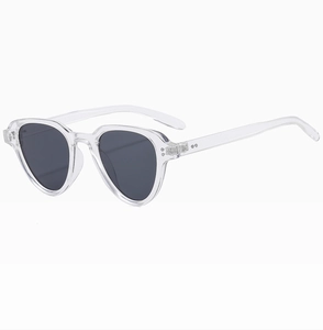 Close-up of transparent plastic frame with metal rivet details and dark lenses