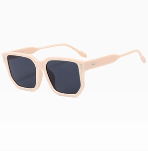 Detail of oversized square light pink frame sunglasses with dark black polarized lenses