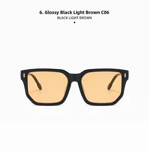 Detail of square black sunglasses with light brown lenses and silver hinge rivets