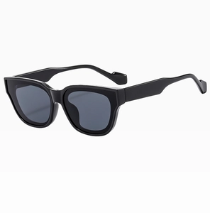 Detail view of large square black fashion sunglasses with sleek dark lenses and sturdy frame