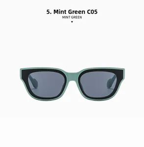 Detail of square mint green and black frames with premium grey protective lenses