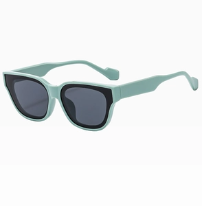 Detail of trendy square sunglasses with mint green and black contrast frame and dark lenses
