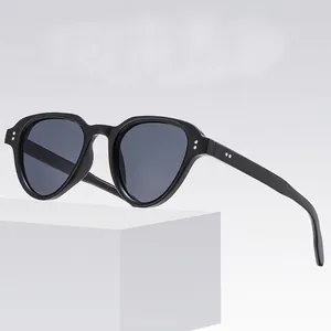Retro black rectangular sunglasses with silver rivets on a white geometric stand