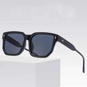 Chic black oversized square sunglasses with signature metal rivet details on the frame