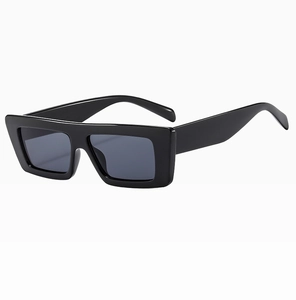 Detail einer dicken eckigen Sonnenbrille in Schwarz mit dunkelgrauen Gläsern