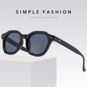 Chic punk style white sunglasses with silver accents and grey lenses on a white pedestal