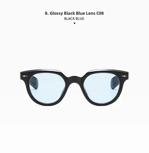 Close-up of bright black oval sunglasses with blue lenses and metal rivet details