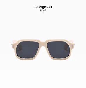 Detail view of beige square sunglasses with thick temples and metal hinge accents