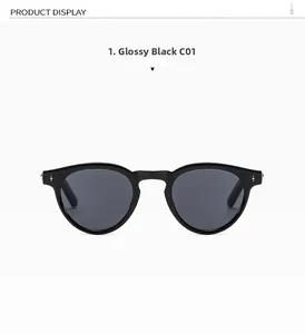 Detail view of oval shiny black sunglasses featuring silver star rivets and dark lenses