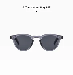 Detail of transparent grey oval sunglasses with silver star accents and dark lenses