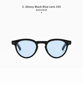 Close-up of retro oval sunglasses featuring black frames and light blue lenses with silver stars