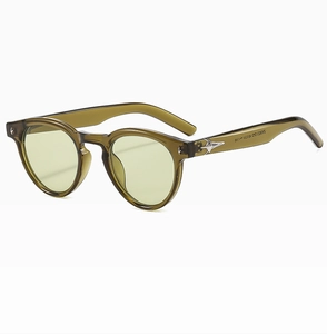 Detail of retro oval sunglasses with star metal accents and green translucent frames