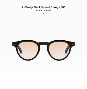 Detail of retro oval black sunglasses featuring C05 sunset orange gradient lenses