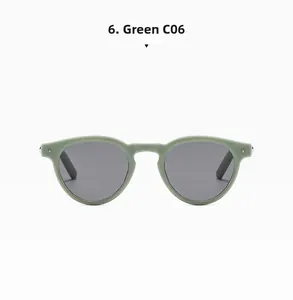 Front view of oval green matte sunglasses with dark lenses and star rivet accents