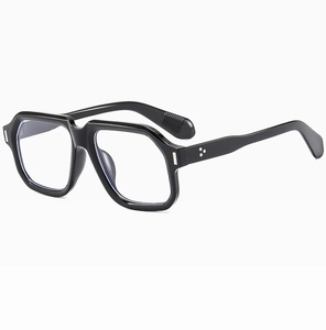 Macro detail of glossy black square frame sunglasses featuring classic silver metal rivets