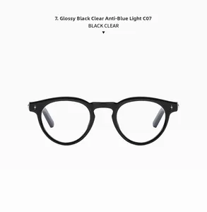 Detail of glossy black oval sunglasses frame featuring star-shaped metal accents
