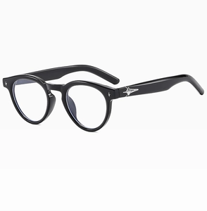 Detailed view of black oval sunglasses with silver star accents and blue light coating