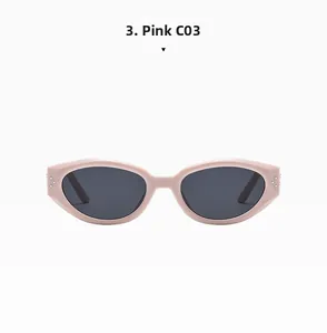 Close-up of pink oval cat-eye sunglasses with silver rivets and dark grey lenses