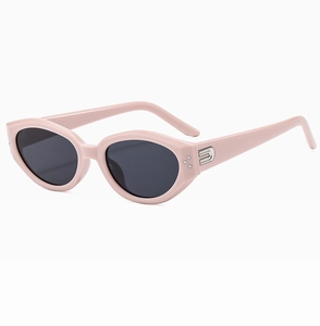 Detail of pink cat-eye sunglasses with silver rivets and sleek metallic temples