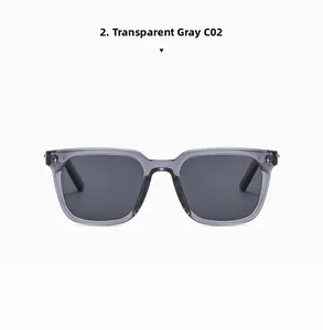 Detail of transparent grey square sunglasses with decorative cross metal hinge and dark lenses