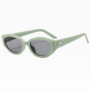Close-up of cat-eye sunglasses hinge with silver dots and metallic letter decoration