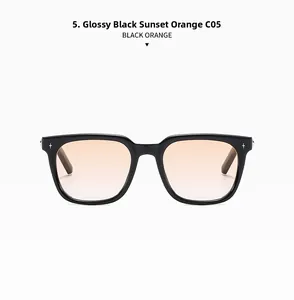 Detail of retro black square sunglasses featuring orange lenses and silver star accents