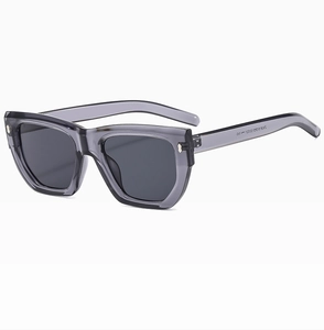 Close-up of translucent grey square frame sunglasses with white printed model number ZN5818