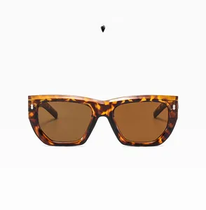 Detail of tortoiseshell square sunglasses with large frames and silver rivet accents