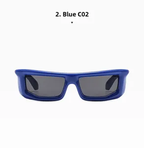 Detail view of bold blue thick frame sunglasses with dark grey lenses and wide temples