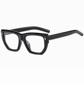 Close-up of black cat-eye eyeglass frames with silver metal rivet detail and clear lenses