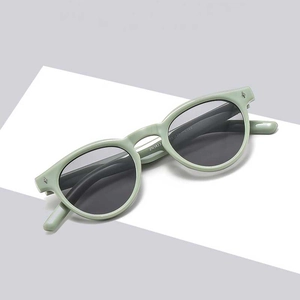 Fashionable light green oval sunglasses with grey lenses and ZN3823 model code on the arm