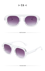 Detail of transparent sunglasses with vertical wavy stripes and purple gradient lenses