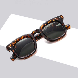 Oversized tortoiseshell square frame sunglasses with dark grey lenses and silver rivets